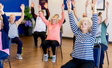 Ouderen doen mee aan de een les stoelfitness